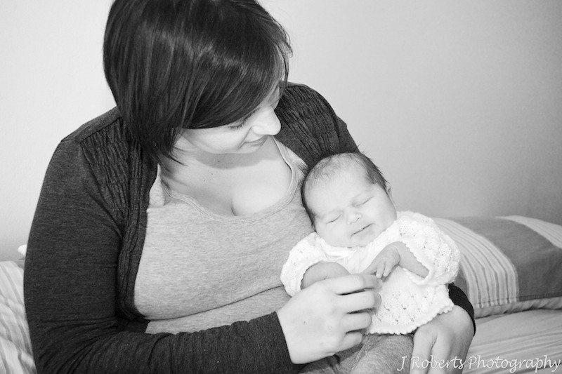 Mummy cuddling with a newborn baby - newborn baby portrait photography sydney